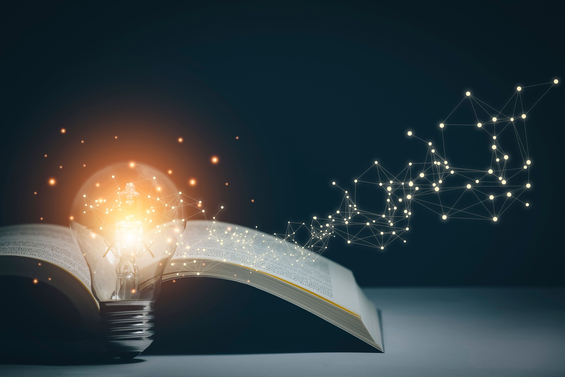 Thinking and creative concept, Light bulb on the Book and light bulb style bokeh vintage dark background,Concept The idea of reading books, knowledge, and searching for new ideas.